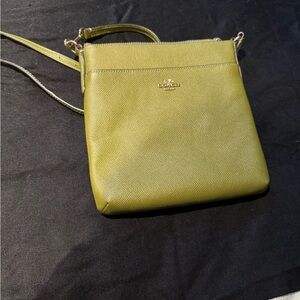 Coach green cross body bag. The color is a little darker than the photograph.